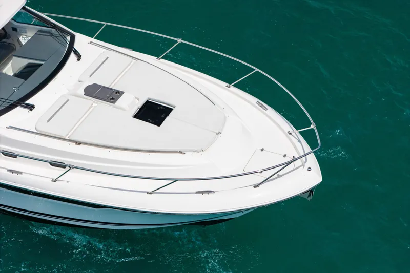 Slide: The Image of 2025 Pursuit OS 405 Offshore boat on clear turquoise water. - 3
