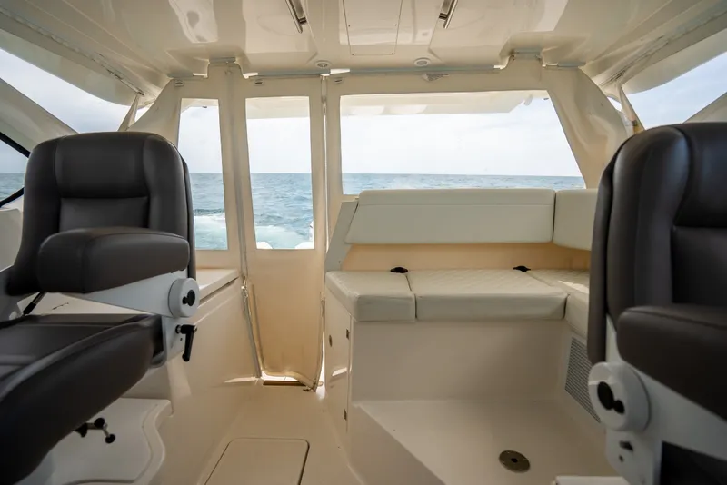 Slide: The Image of Interior of 2025 Pursuit OS 405 Offshore boat with ocean view through windows. - 46