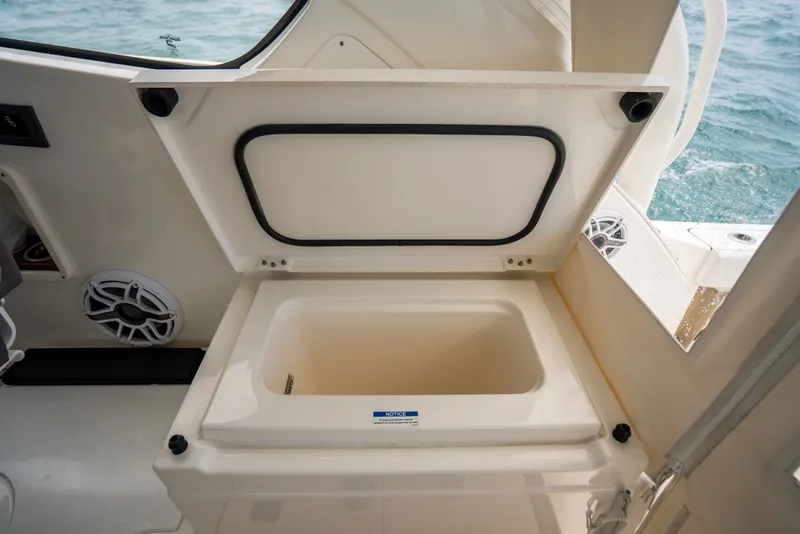 Slide: The Image of Open storage compartment on 2025 Pursuit OS 405 Offshore boat interior. - 36