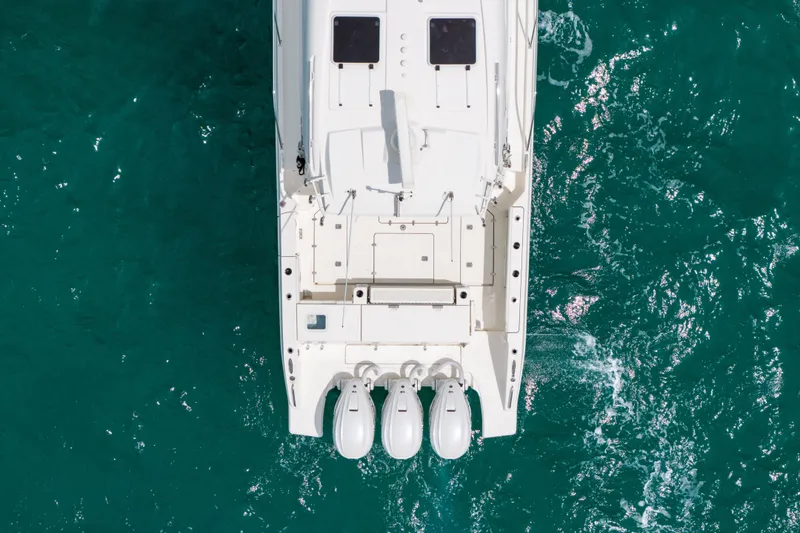 Slide: The Image of Aerial view of 2025 Pursuit OS 405 Offshore boat on turquoise water. - 7