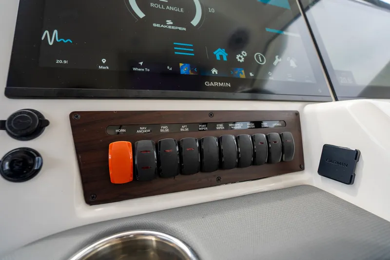 Slide: The Image of Control panel of 2025 Pursuit OS 405 Offshore boat with Garmin display and switches. - 41