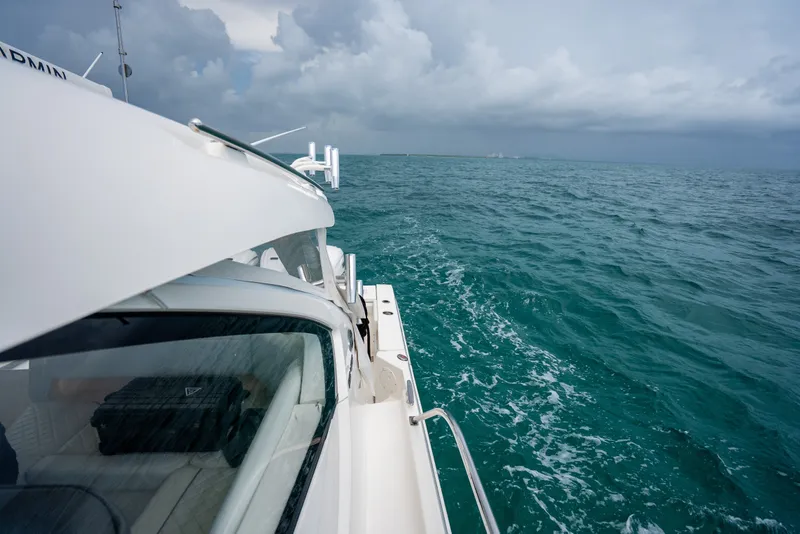 Slide: The Image of 2025 Pursuit OS 405 Offshore cruising on open ocean under cloudy skies. - 22
