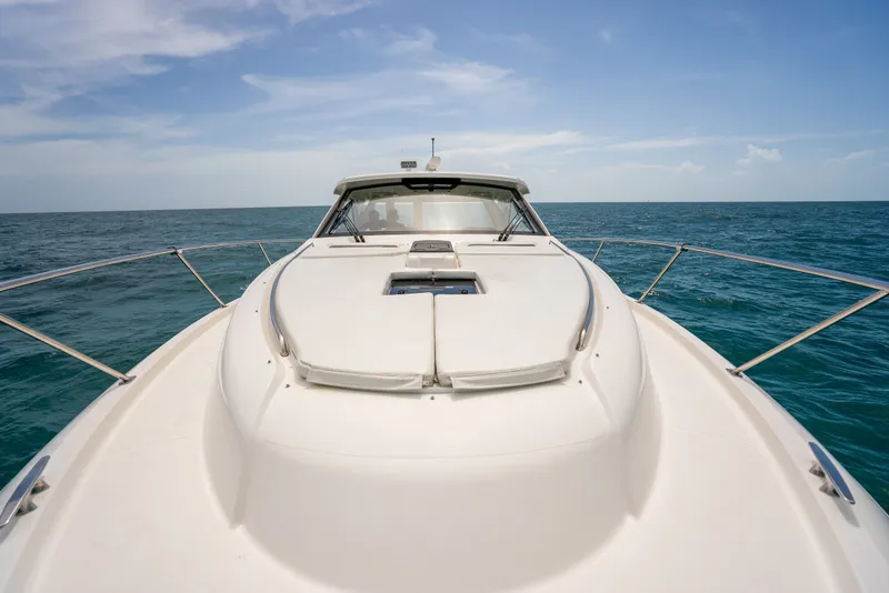 Slide: The Image of 2025 Pursuit OS 405 Offshore boat cruising on open sea under clear sky. - 49