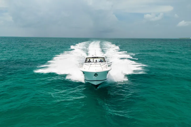 Slide: The Image of 2025 Pursuit OS 405 Offshore cruising on open turquoise waters. - 14