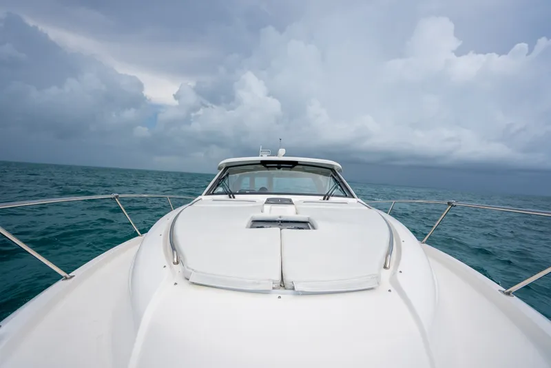 Slide: The Image of 2025 Pursuit OS 405 Offshore yacht cruising on open sea under cloudy skies. - 18