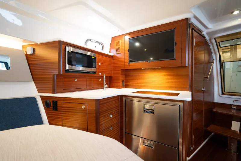 Slide: The Image of Luxurious interior of 2025 Pursuit OS 405 Offshore yacht featuring modern kitchen amenities. - 53