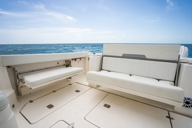 Slide: The Image of 2025 Pursuit OS 405 Offshore boat interior with white seating, ocean view. - 34