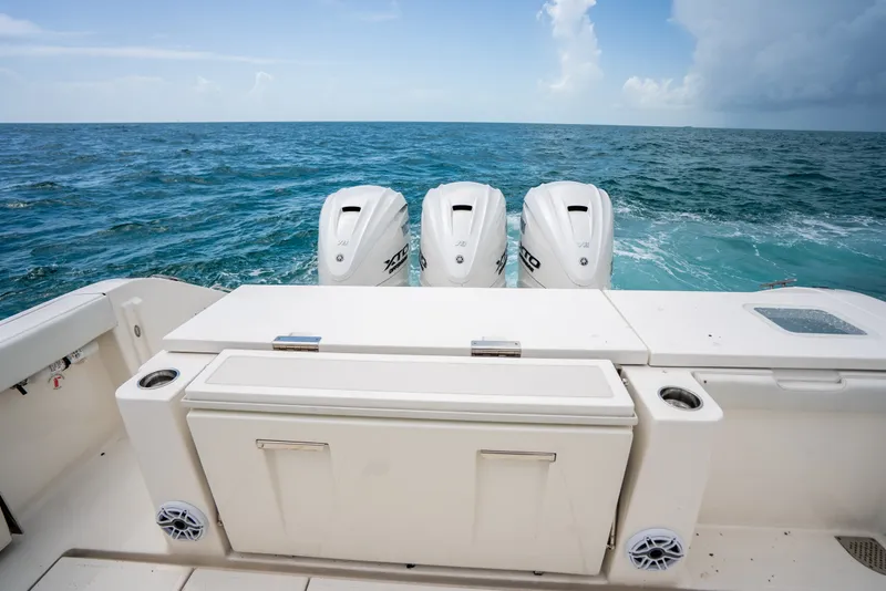 Slide: The Image of 2025 Pursuit OS 405 Offshore boat with triple outboard engines on open sea. - 25