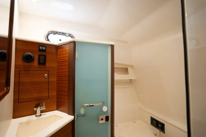 Slide: The Image of 2025 Pursuit OS 405 Offshore yacht bathroom with modern fixtures and wood accents. - 61