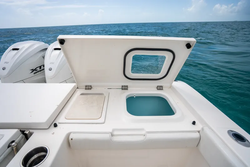 Slide: The Image of 2025 Pursuit OS 405 Offshore boat with open hatch, ocean view. - 29
