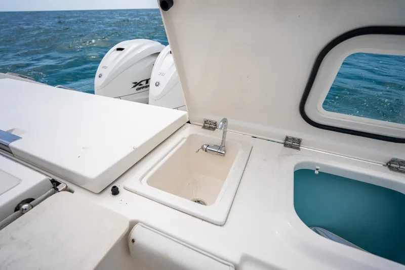 Slide: The Image of 2025 Pursuit OS 405 Offshore boat sink and engine detail at sea. - 30