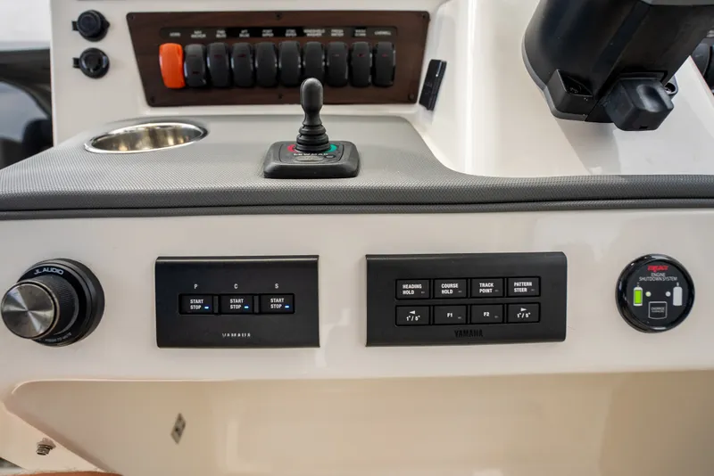 Slide: The Image of Control panel of 2025 Pursuit OS 405 Offshore boat with Yamaha systems and JL Audio knob. - 42