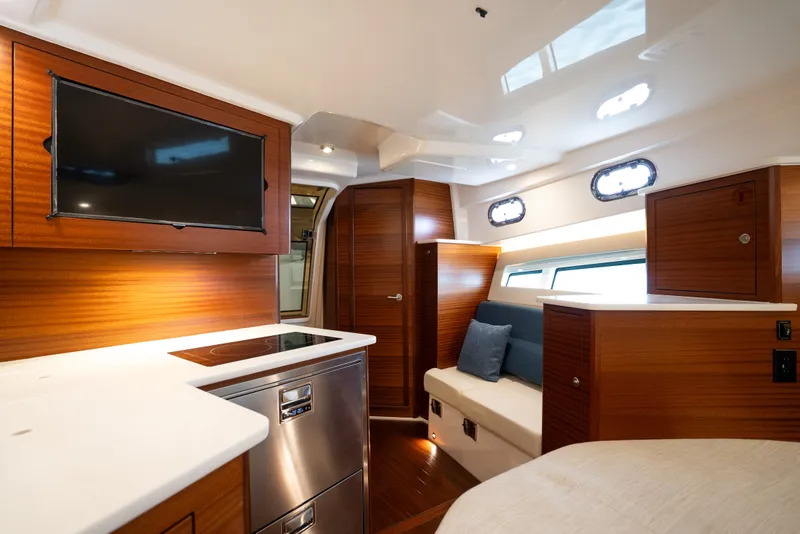 Slide: The Image of Luxurious interior of 2025 Pursuit OS 405 Offshore yacht with modern amenities and elegant wood finishes. - 54