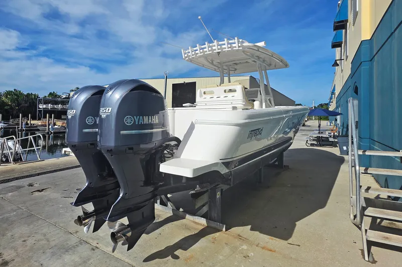Slide: The Image of 2015 Intrepid 327 Center Console boat with twin Yamaha 350 engines on a dock. - 7