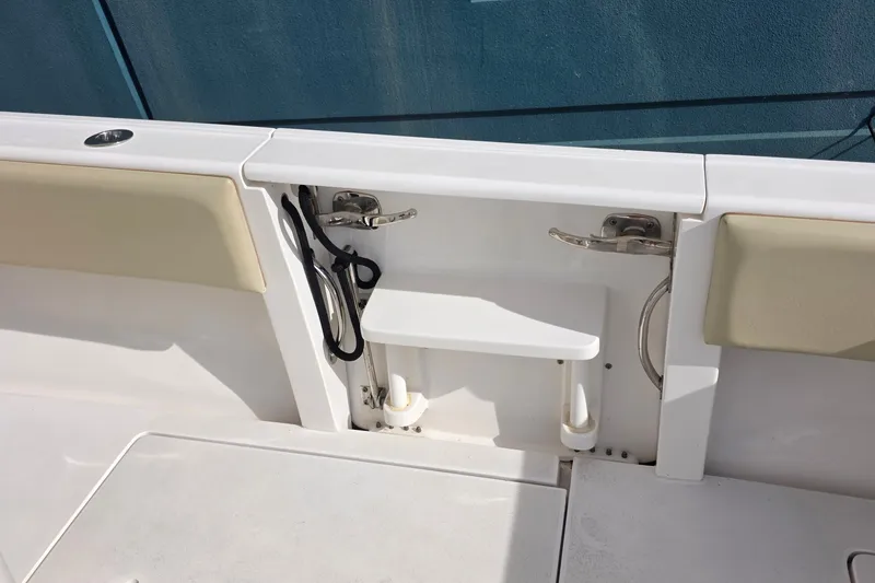 Slide: The Image of 2015 Intrepid 327 Center Console boat interior with seating and storage features. - 35