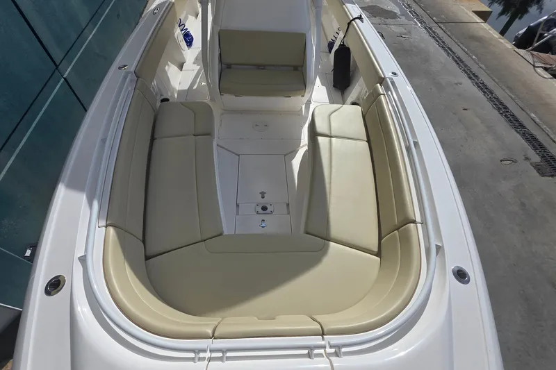 Slide: The Image of 2015 Intrepid 327 Center Console boat with beige seating and spacious deck layout. - 15