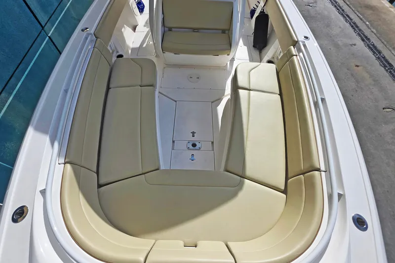 Slide: The Image of 2015 Intrepid 327 Center Console boat with beige seating and spacious deck layout. - 9