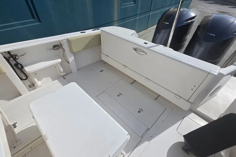 Slide: The Image of 2015 Intrepid 327 Center Console boat interior with seating and dual engines. - 25