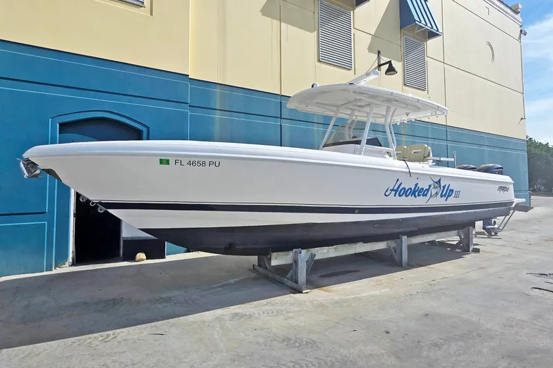 Slide: The Image of 2015 Intrepid 327 Center Console boat on display, labeled "Hooked Up III." - 2