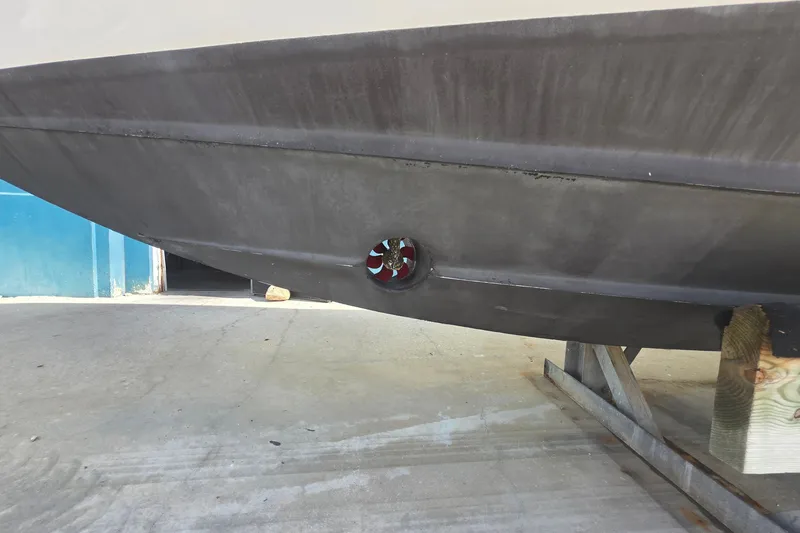 Slide: The Image of 2015 Intrepid 327 Center Console hull with visible thruster on dry dock. - 8