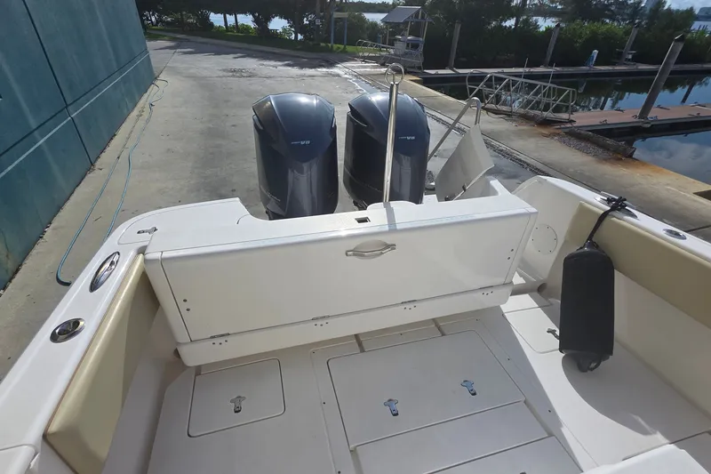 Slide: The Image of 2015 Intrepid 327 Center Console boat with dual outboard engines at dockside. - 27