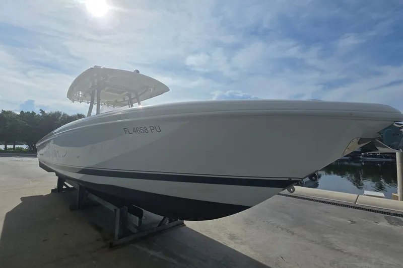 Slide: The Image of 2015 Intrepid 327 Center Console boat on dock under clear sky. - 6