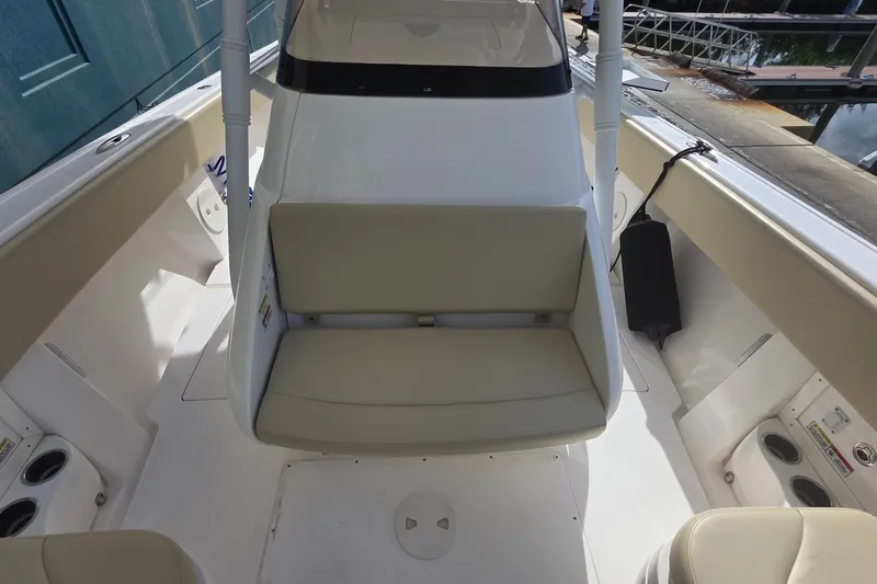 Slide: The Image of 2015 Intrepid 327 Center Console boat interior with seating and cup holders. - 19