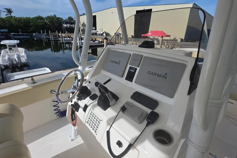 Slide: The Image of 2015 Intrepid 327 Center Console boat dashboard with Garmin navigation system. - 22
