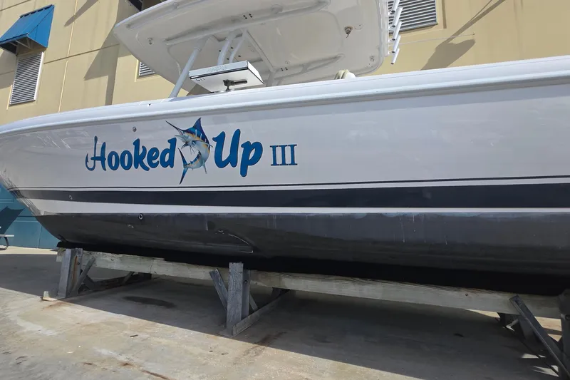 Slide: The Image of 2015 Intrepid 327 Center Console boat named "Hooked Up III" on a stand. - 7