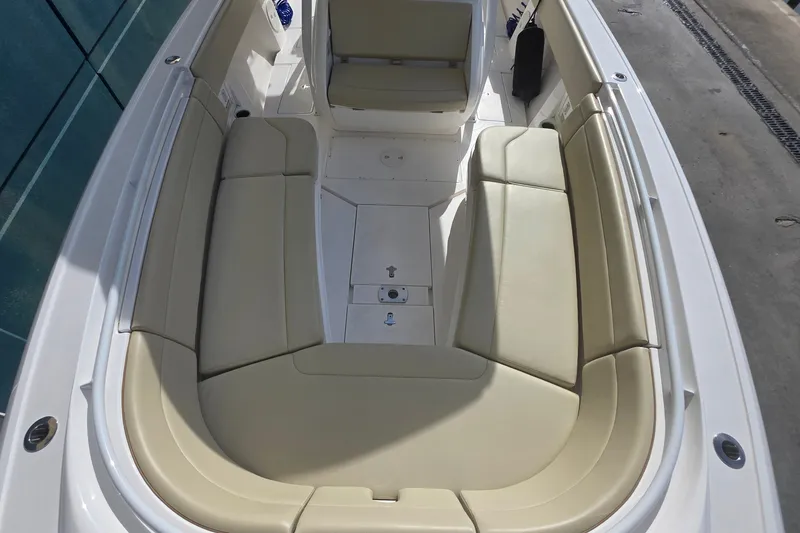 Slide: The Image of 2015 Intrepid 327 Center Console boat with spacious beige seating area. - 17