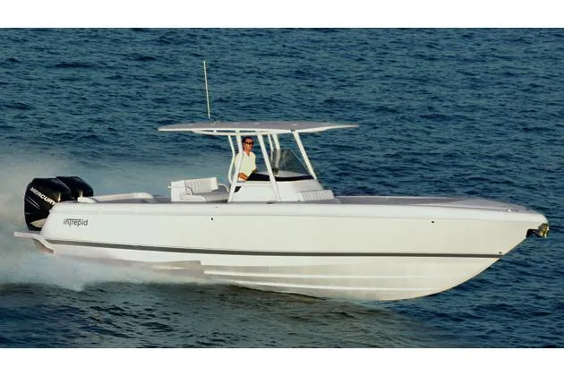 Slide: The Image of Manufacturer Provided Image: 2015 Intrepid 327 Center Console boat cruising on the water. - 1