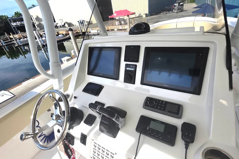 Slide: The Image of 2015 Intrepid 327 Center Console helm with advanced navigation and control systems. - 23