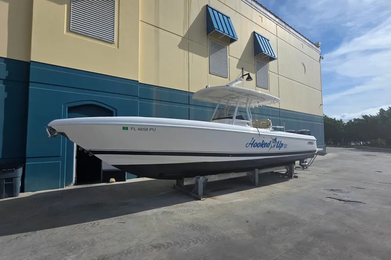 Slide: The Image of 2015 Intrepid 327 Center Console boat on dry dock, labeled "Hooked Up III." - 9