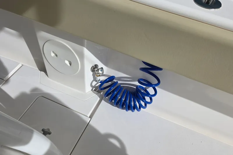 Slide: The Image of Blue coiled hose on 2015 Intrepid 327 Center Console boat deck. - 34
