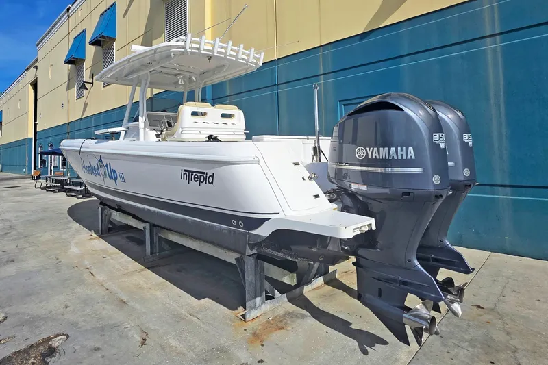 Slide: The Image of 2015 Intrepid 327 Center Console boat with twin Yamaha engines on display. - 32