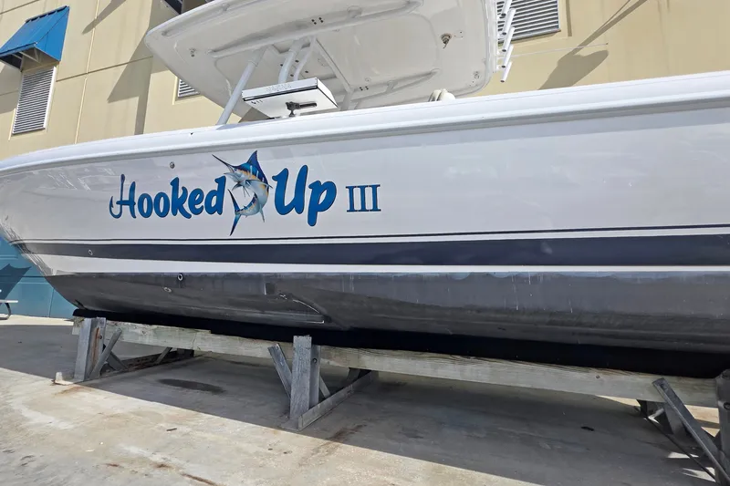Slide: The Image of 2015 Intrepid 327 Center Console boat named "Hooked Up III" on a stand. - 16