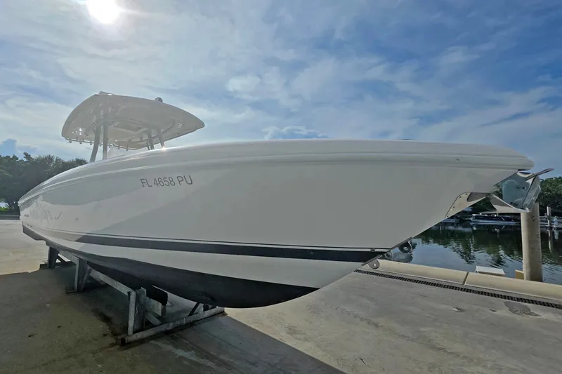 Slide: The Image of 2015 Intrepid 327 Center Console boat on dock under clear sky. - 33