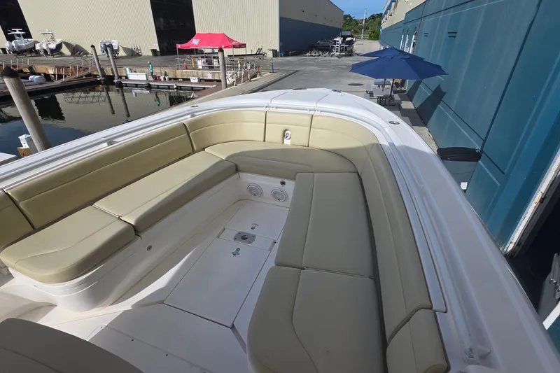 Slide: The Image of 2015 Intrepid 327 Center Console boat with spacious seating area at dockside. - 11