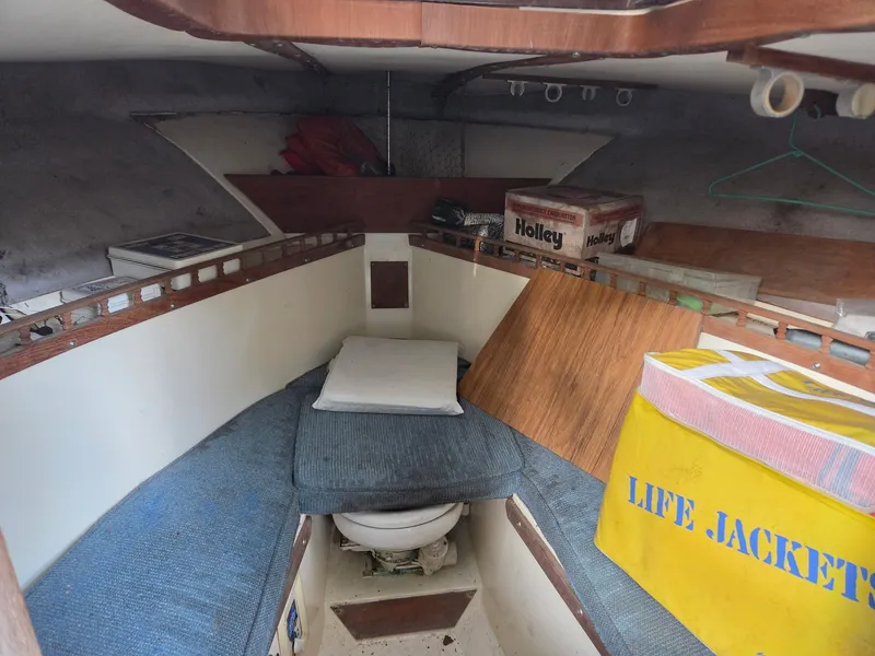 Slide: The Image of The image shows the interior of a 1989 Mako 286 with a sleeping berth and storage. - 4