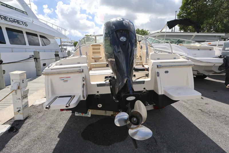 Slide: The Image of 2023 Scout 210 Dorado boat with outboard motor at marina dock. - 5