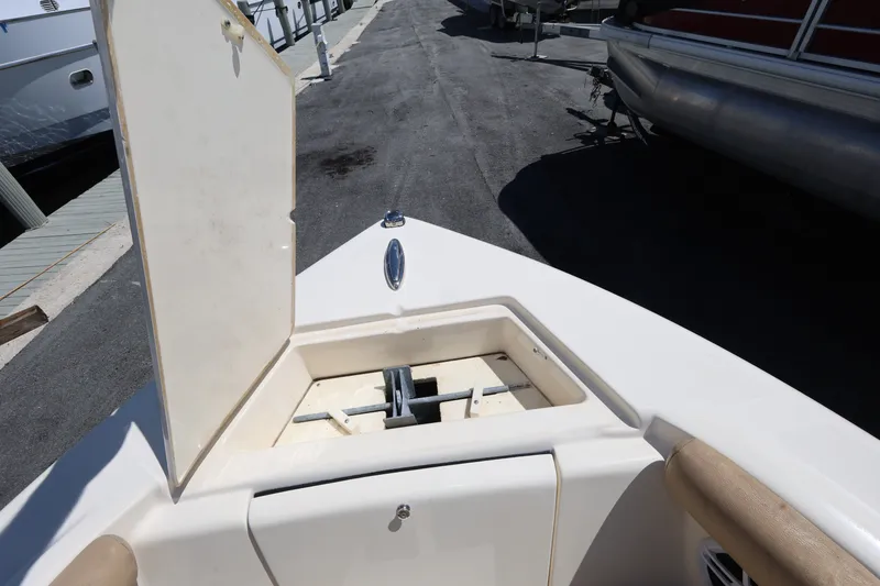 Slide: The Image of Open anchor compartment on 2023 Scout 210 Dorado boat at dockside. - 15