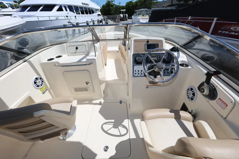 Slide: The Image of 2023 Scout 210 Dorado boat interior with steering wheel and seating. - 11