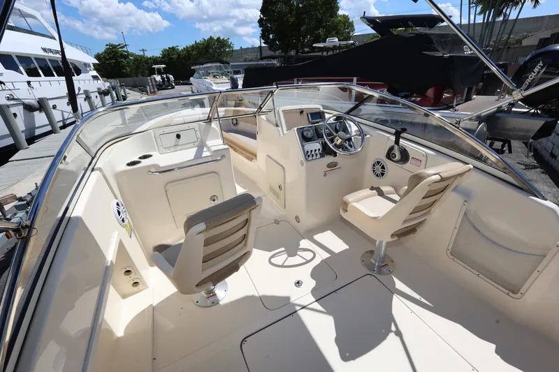 Slide: The Image of 2023 Scout 210 Dorado boat interior with steering wheel and seating. - 10