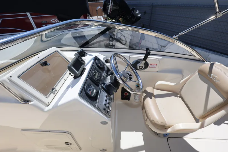 Slide: The Image of 2023 Scout 210 Dorado boat cockpit with steering wheel and control panel. - 20