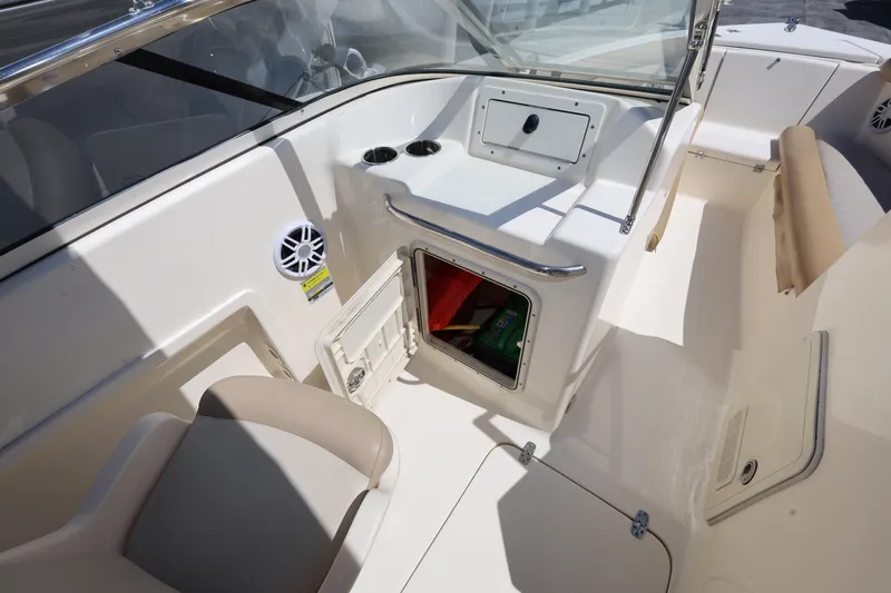 Slide: The Image of 2023 Scout 210 Dorado boat interior with storage compartment and seating area. - 19
