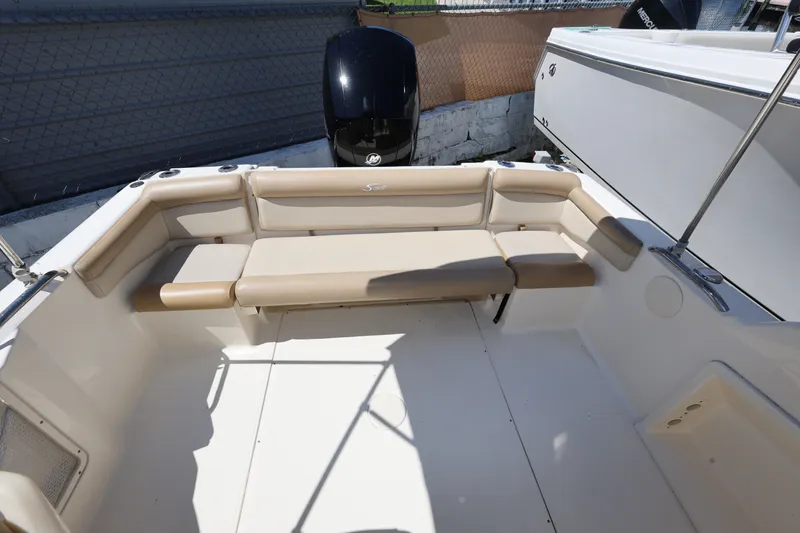 Slide: The Image of 2023 Scout 210 Dorado boat interior with beige seating and outboard motor. - 21