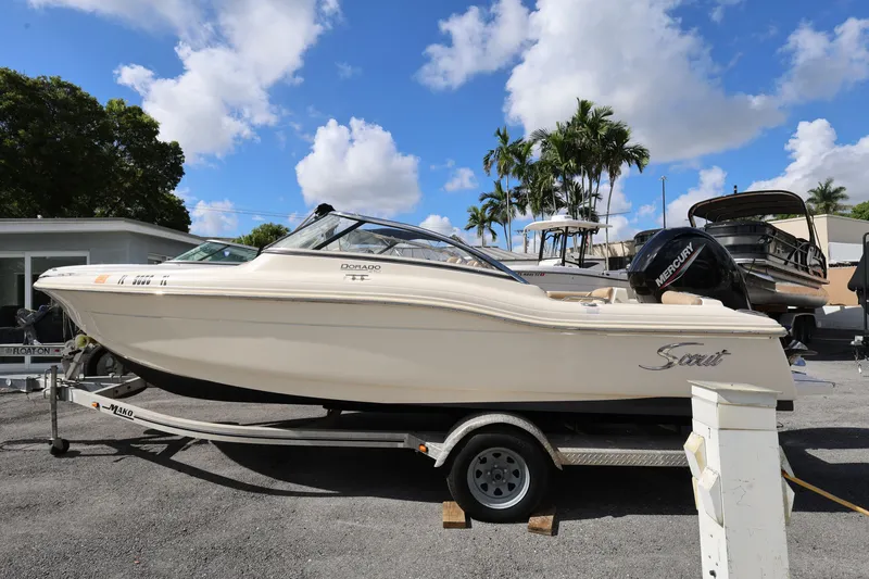 Slide: The Image of 2023 Scout 210 Dorado boat on trailer under blue sky with clouds. - 3