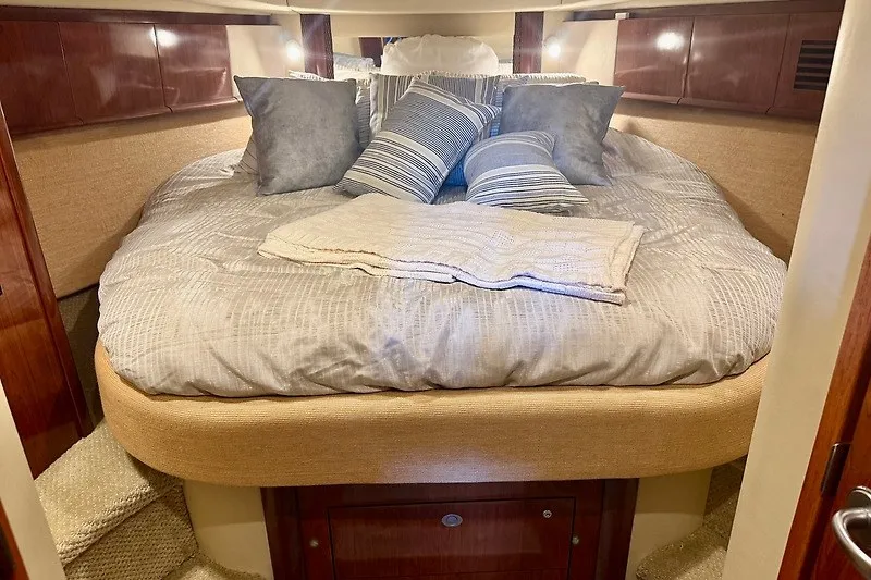 Slide: The Image of Luxurious cabin interior of 2005 Sea Ray 390 Sundancer with plush bedding and pillows. - 14
