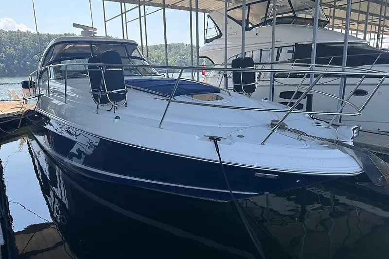 Slide: The Image of 2005 Sea Ray 390 Sundancer yacht docked in a marina, side view. - 20
