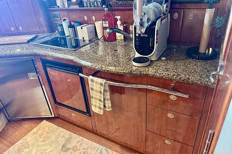 Slide: The Image of Luxurious 2005 Sea Ray 390 Sundancer yacht kitchen with granite countertops and modern appliances. - 10